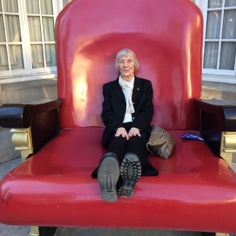 Carol Johnston smiling and sitting in an oversized chair